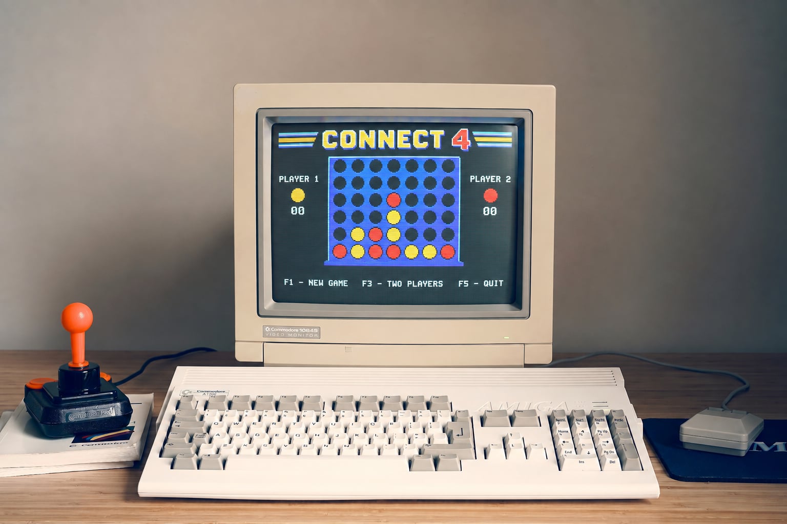 Connect-4 running on an Amiga-style computer with a joystick beside it